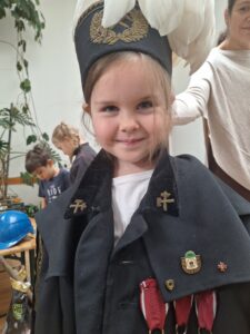 dziewczynka w galowym stroju górnika i czako na głowie